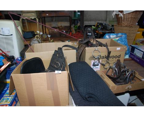 A box of saddlery including horse Numnahs, hat covers, gloves, harness, stirrups, bits, head collar, carriage whip, etc.