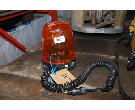 An orange rotating, flashing beacon with cigarette lighter feed plug.