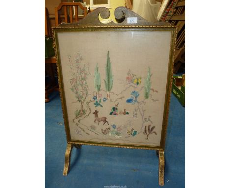A tapestry fire screen.