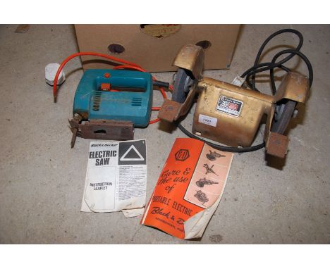 A "Black and Decker" bench grinder and a "Black and Decker" electric hand saw (working at time of lotting).