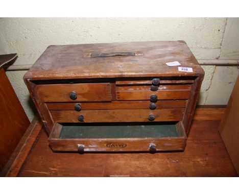 A small vintage tool chest with various drawers.