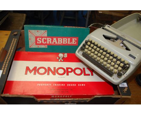 A box of games to include: Cluedo, Monopoly, Scrabble and a "Adler" typewriter (in working order at time of lotting). 