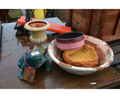 A frog ornament and a planter.