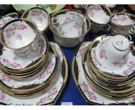 An Early XX Century Rose Floral Tea Service, of thirty nine pieces with blue and gilt borders.
