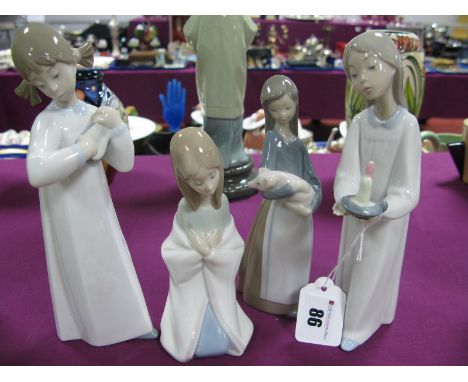 Four Lladro Pottery Figurines.