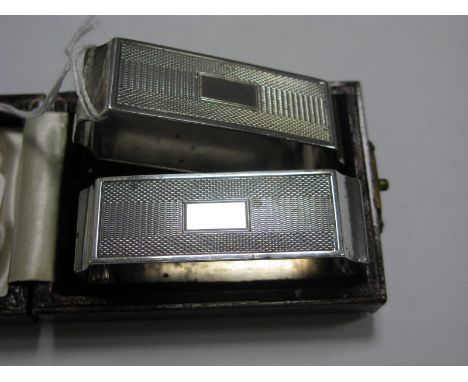 A Pair of Hallmarked Silver Napkin Rings, of elongated form, engine turned, in a fitted case.