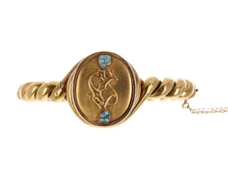 Antique yellow metal rope twist design hinged bangle, the oval monogrammed plaque set with small turquoise, with safety chain