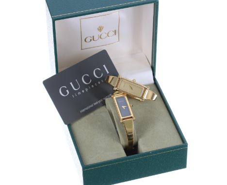 Gucci 1500 gold plated lady's bangle wristwatch, champagne dial,&nbsp;quartz, 30mm x 12mm; together with a Gucci 1500L gold p