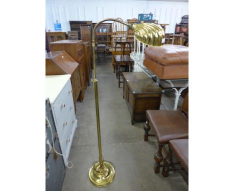 A brass floor standing lamp