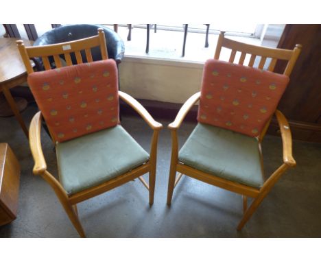 A pair of Ercol Blonde ash elbow chairs 