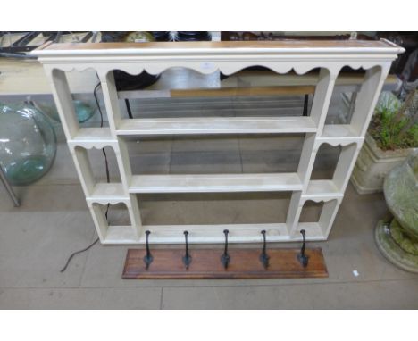 A painted pine wall shelf and a set of coat hooks 