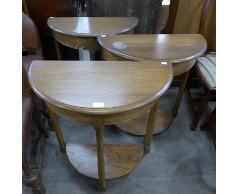 Three Ercol Golden Dawn elm and demi-lune side tables 