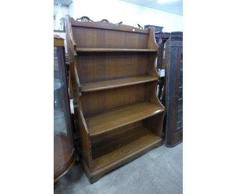 An Ercol Golden Dawn elm open bookcase 
