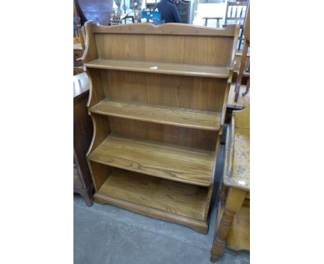 An Ercol Golden Dawn elm open bookcase 