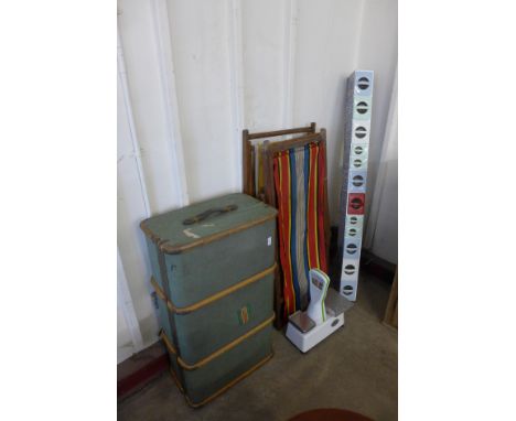 A steamer trunk, three deck chairs, a set of scales and spice drawers 