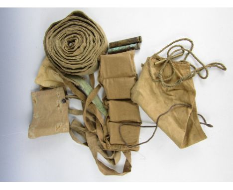 A small group of British Army small arms kit including WWI and later cotton bandoliers, a WWII Vickers machine gun belt, rifl