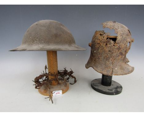 Two relic First World War helmets on stands