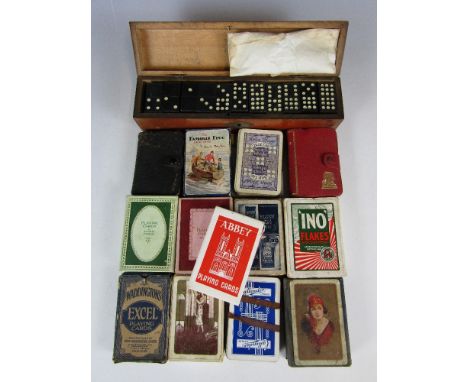 A cased set of dominoes together with playing cards
