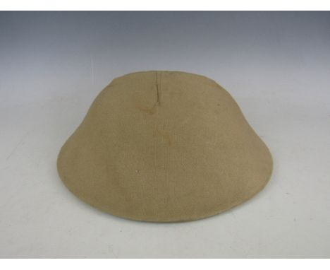 A restored First World War Brodie helmet and cover