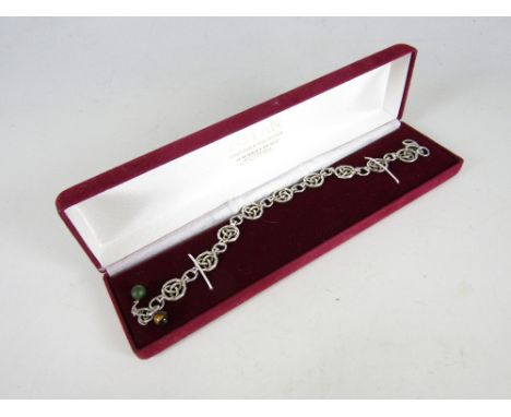 A contemporary sterling silver bracelet, having circular cabled links centered by celtic knots, 22 cm 