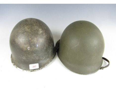 A WWII US Army 'front seam' M1 helmet and a later example