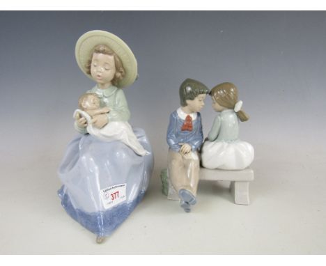 Two Nao figures including Girl with baby and a boy with girl on a bench