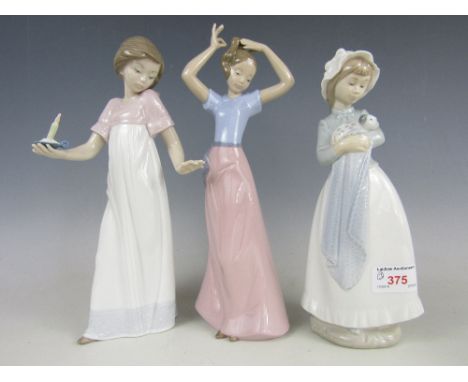 Three Nao figures including Girl with puppy and two others 