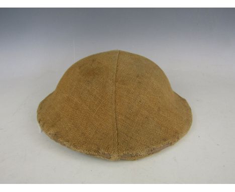 A reproduction First World War Brodie helmet and cover