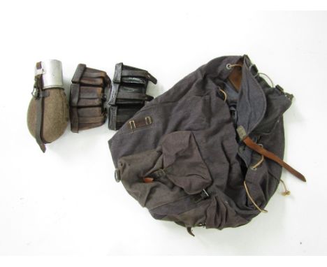 A WWII German army water bottle, a blue-grey rucksack and ammunition pouches