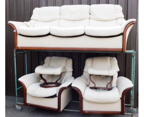 A Streessless cream leather sofa, comprising a three seater sofa and two matching arm chairs. (AF)