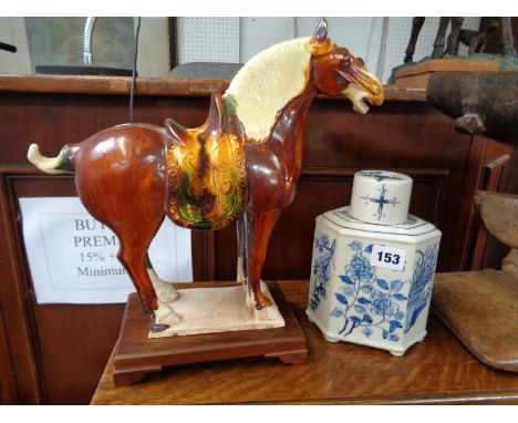 Chinese Pottery Tang type horse on wooden plinth and a Blue & White Pottery prunus decorated tea caddy