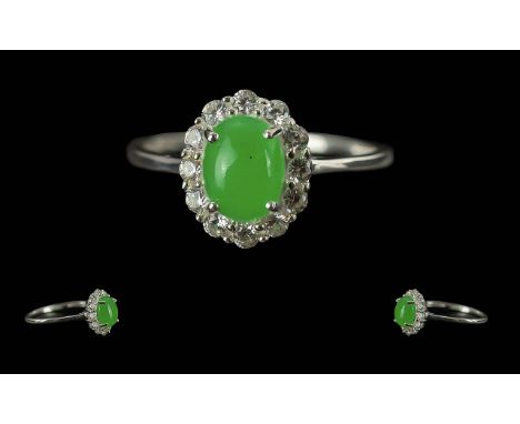 Chinese Jade and Cambodian Zircon Ring, a classic style with a green jade oval cabochon, framed with natural zircon from Camb