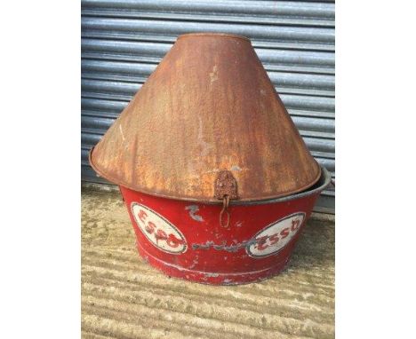 An oval galvanised bath decorated in Esso colours and a 'Perfection' oil cabinet cover. 