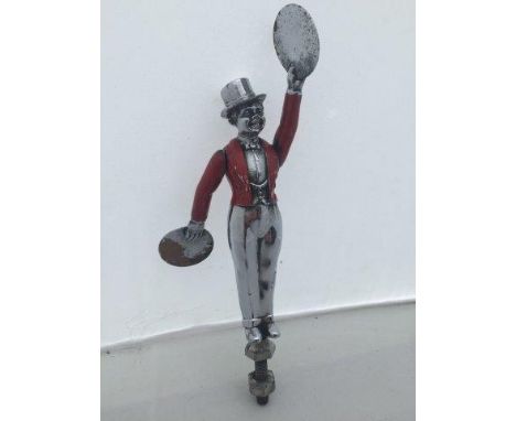 A rare vintage car accessory mascot in the form of a standing figure dressed in a red jacket playing the cymbals, with articu