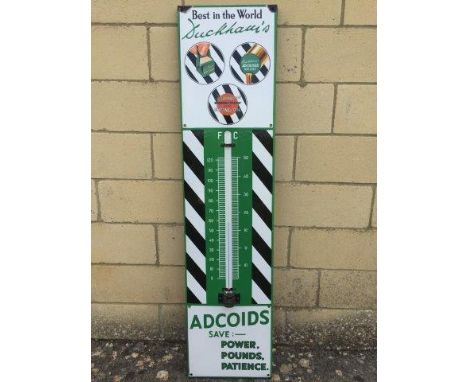 A Duckhams Adcoids Black and White enamel thermometer, in excellent condition and with good gloss, 11 x 45 1/2".