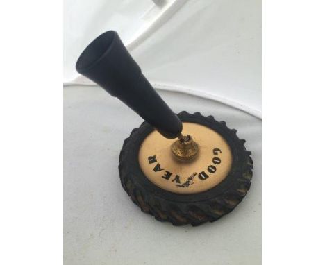 A Goodyear desktop pen holder in the form of a tractor tyre.