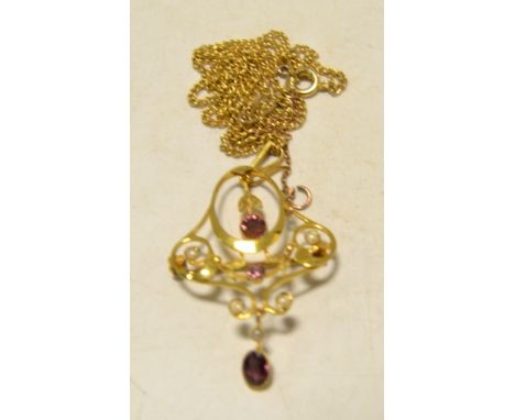 An Art Nouveau gold coloured metal seed pearl and amethyst pendant, gold plated chain