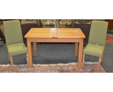 A solid structured light oak dining table; two conforming contemporary dining chairs (3)