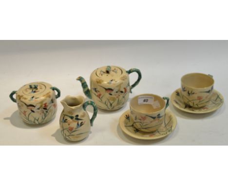 A Japanese Satsuma part tea service, comprising teapot, sugar bowl, milk jug and two teacups and saucers, each decorated in c