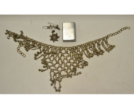 A silver filigree necklace;  an Indian mesh necklace;  a Zippo lighter