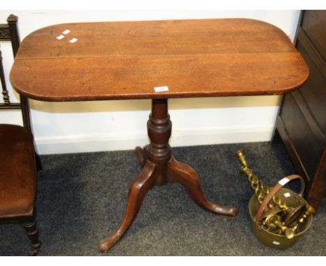 A Victorian oak tilt top table, cannon barrel support , tripod feet, c.1890