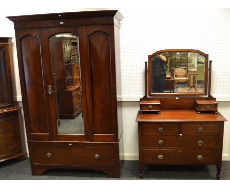 A late 19th Century mahogany two piece bedroom suite comprising wardrobe with overhanging cornice, central mirror decorated i