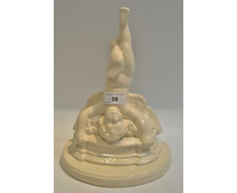 A Poole pottery type wall bracket, as a cherub, oval platform, cream glaze, incised marks, signed FV