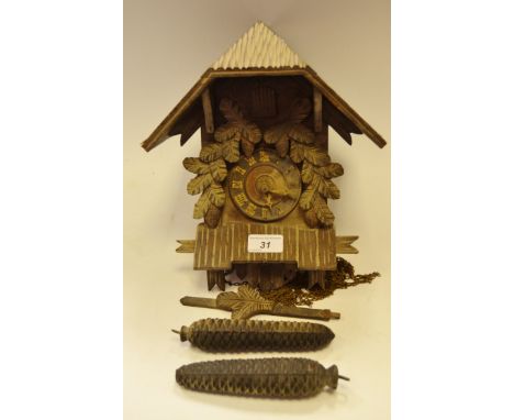 A Blackforest style cuckoo clock, pine cone cast weights (1) 