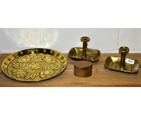 An Art Nouveau hammered brass tray, pair of chamber sticks and a brass box.