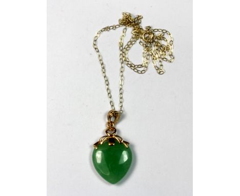 A 14ct yellow gold jade pendant on a 9ct gold chain.