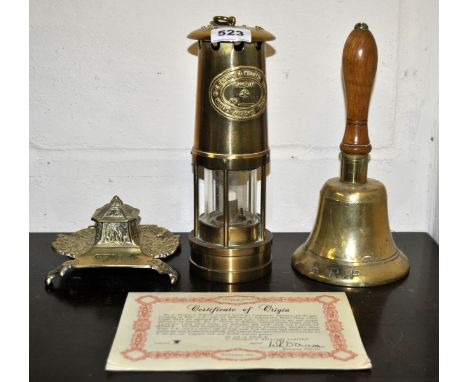 A brass miners lamp, bell and desk stand.