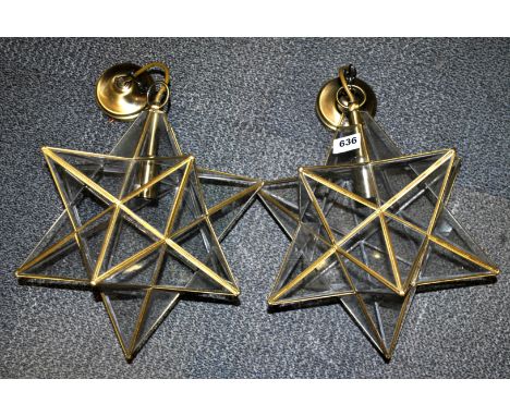 A pair of brass and glass star light fittings.