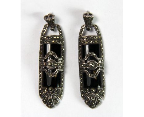 An Art Deco style onyx set silver and marcasite pair of drop earrings.