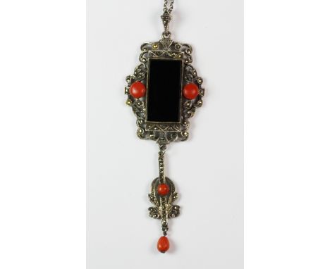 An Art Deco style onyx and coral set silver and marcasite pendant and chain.